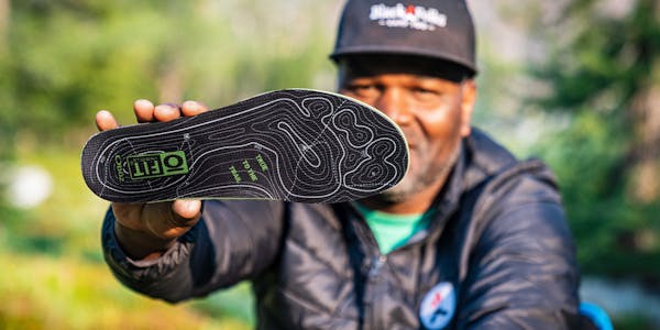 Earl Hunter JR, founder of Black Folks Camp Too, holding the Oboz O FIT Insole Plus II.