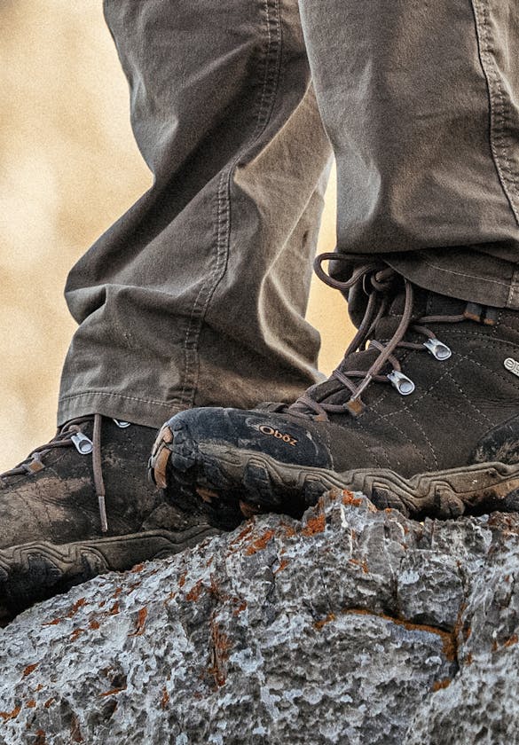 Oboz Men's Bridger Mid hiking boots on top of a rock ledge while on a backpacking trip