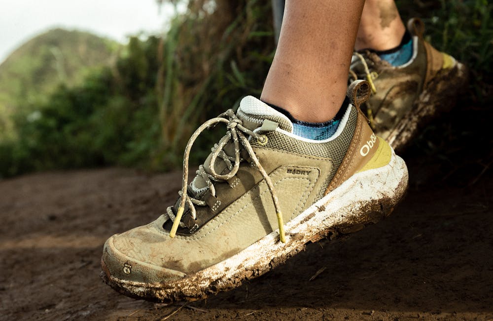 Oboz Cottonwood Low waterproof hiking shoes in the mud.