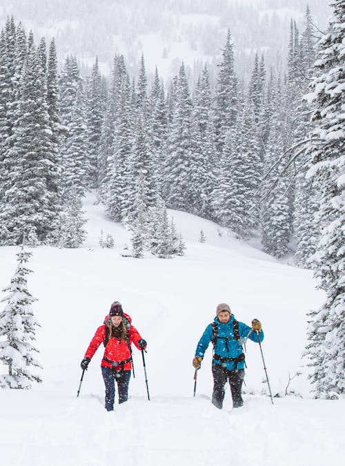 Two people trekking through deep snow in Oboz winter boots