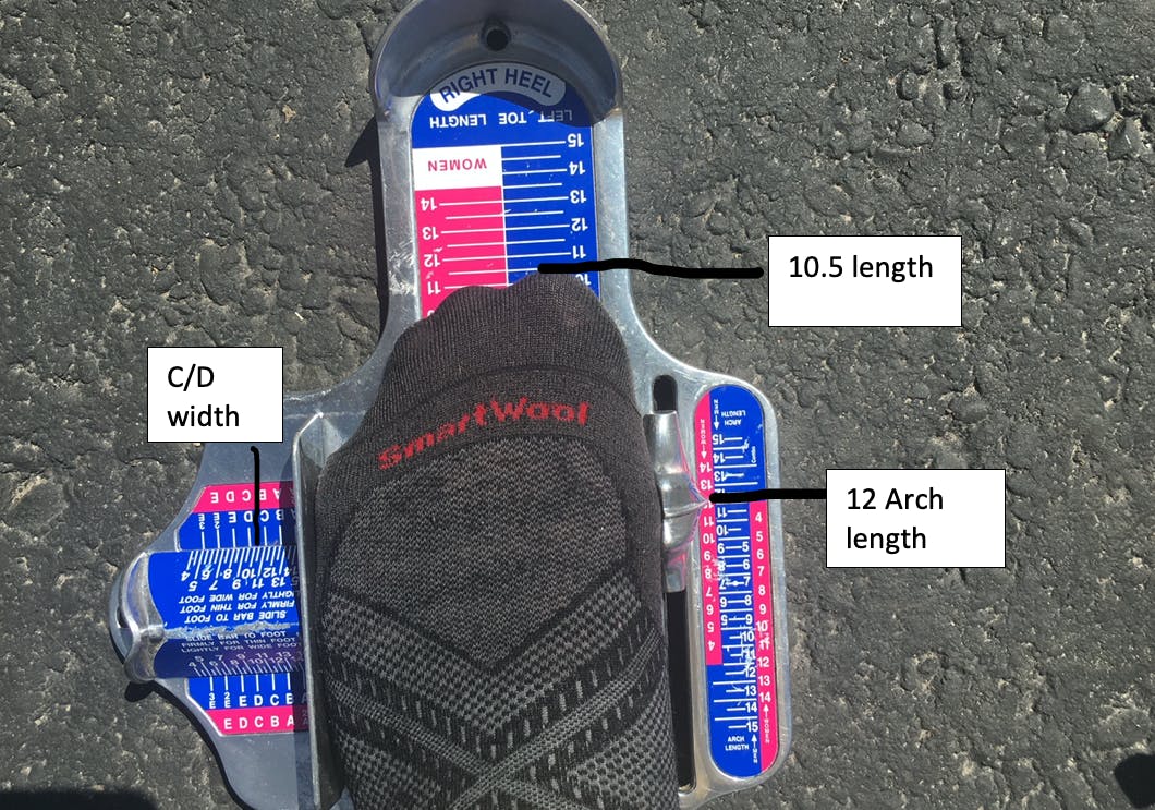 Here, the Brannock device measures this man's foot length at 10.5, arch length at 12, and a foot width at C/D.