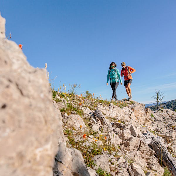 Two people walking in the Oboz Low Leather shoe.