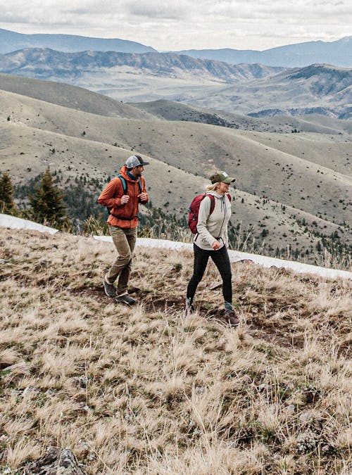 Two hikers on a trail in the mountains outside of Bozeman, MT.