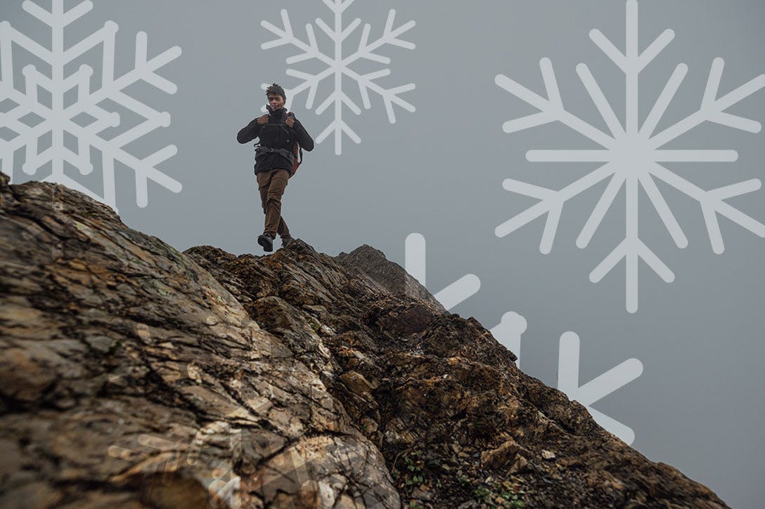 Man hiking a rocky peak in Oboz hiking boots
