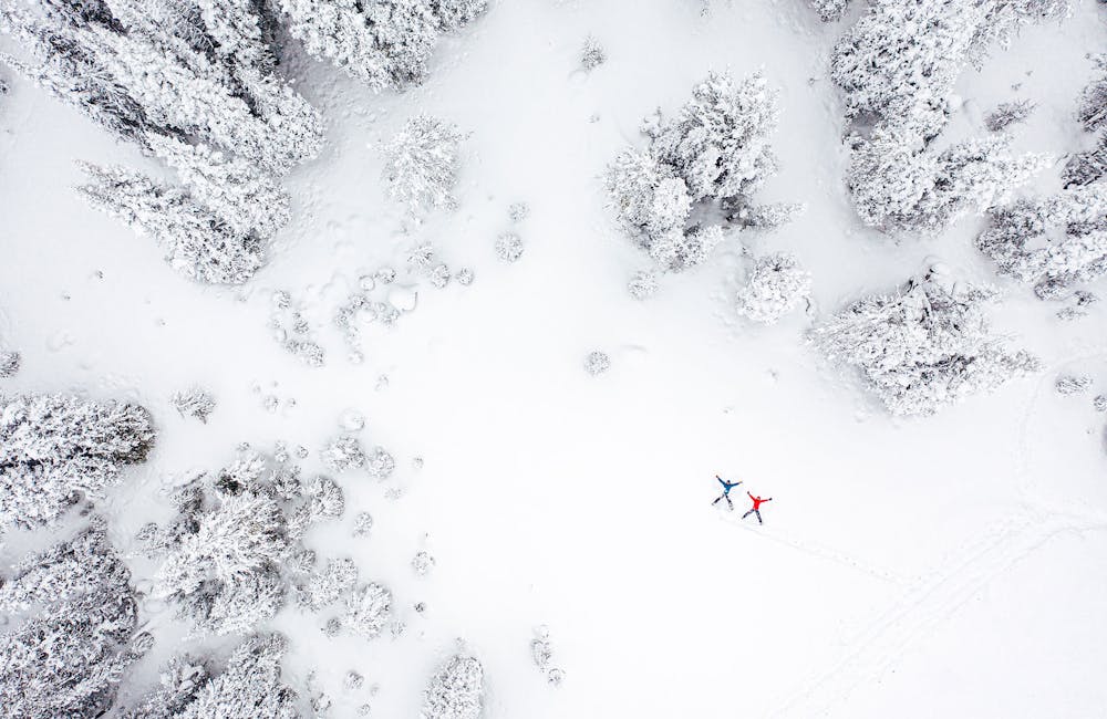 Making snow angels in a winter forest in Oboz hiking boots