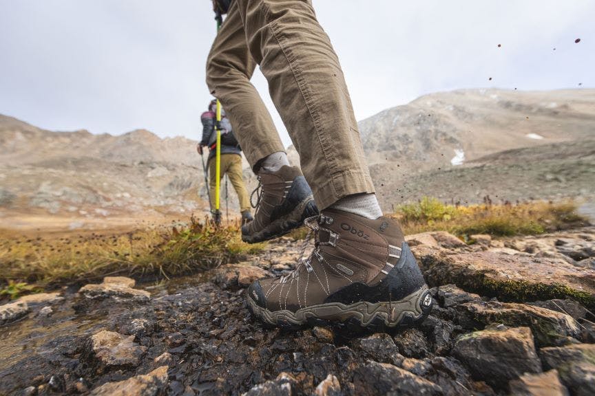 Oboz Bridger Mid hiking boot on rocky terrain hiking through the mountains.
