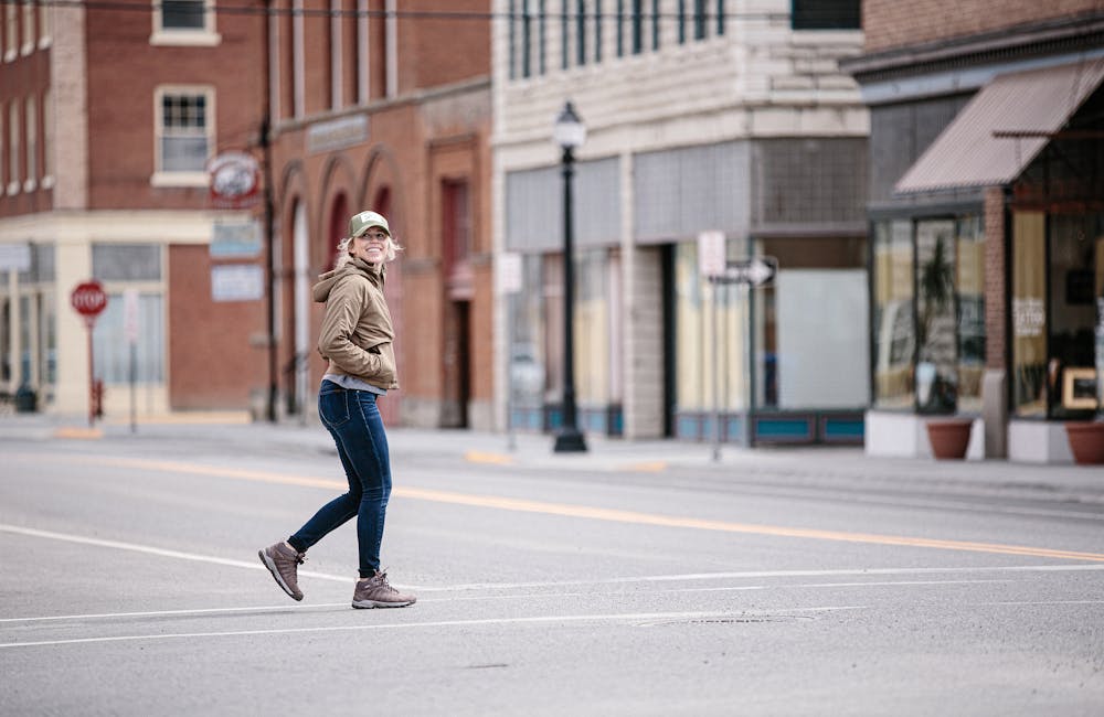 Woman crossing the street in the Oboz Sypes Mid Leather hiking boots.
