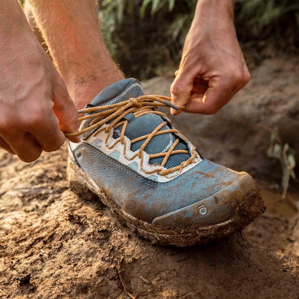 Oboz Cottonwood Low Waterproof hiking shoe on a muddy trail.