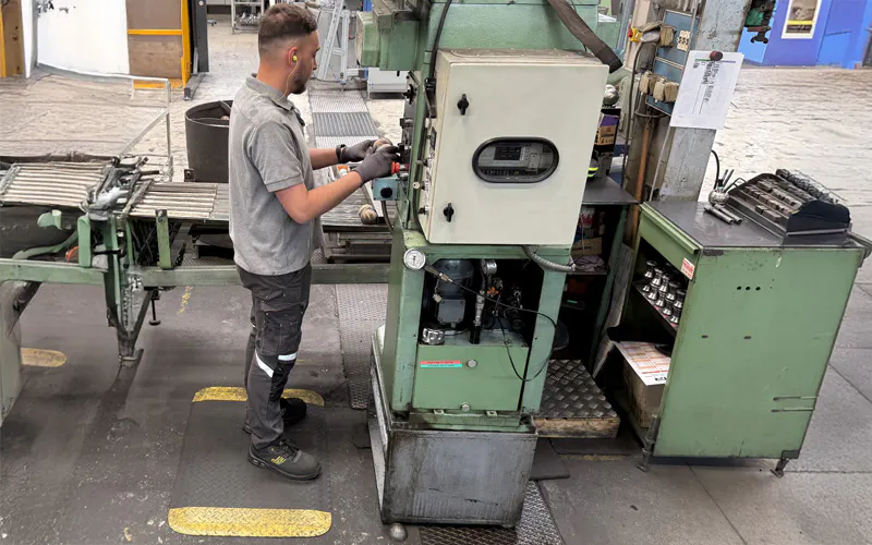 Un tapis anti-fatigue mis à la disposition d'un collaborateur Obut dans les ateliers de fabrication des boules de pétanque.