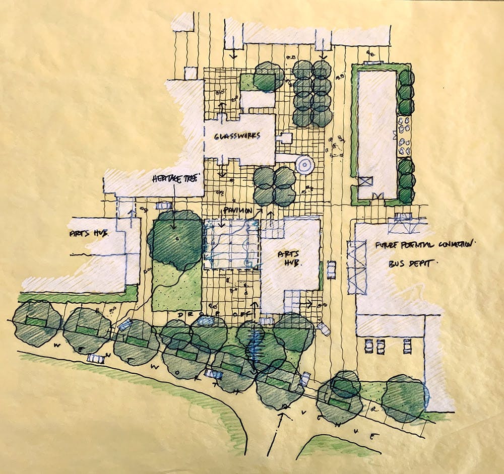 A plan sketched on yellow tracing paper. Buildings are shaded with white pencil. Green trees and open space are shaded green.
