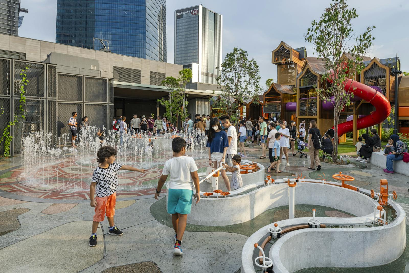 A photo of a busy playground with lots of water play activities.