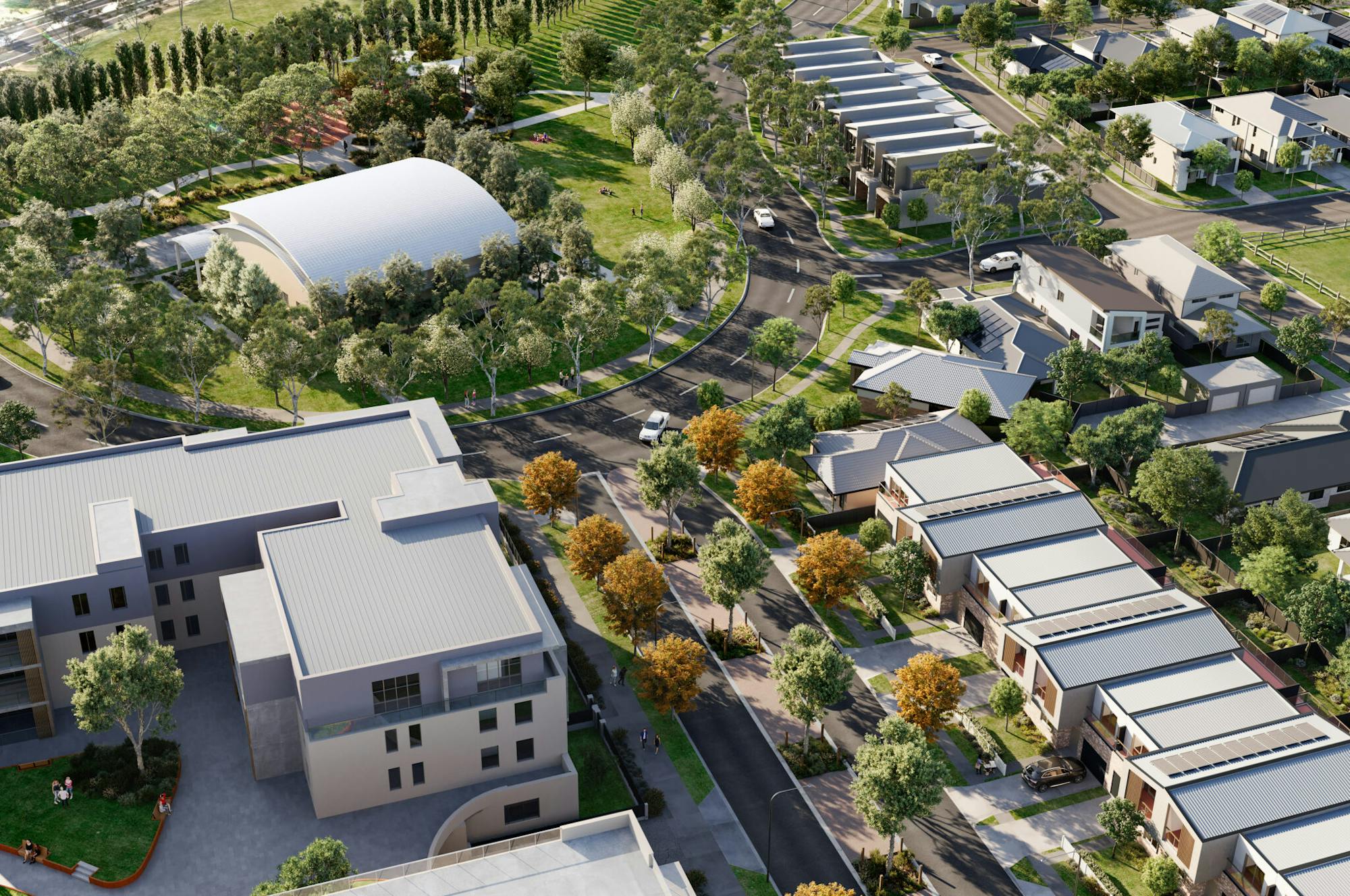 A digital render of a new residential community from above. There is an apartment building, townhouses, open space, and lots of trees.