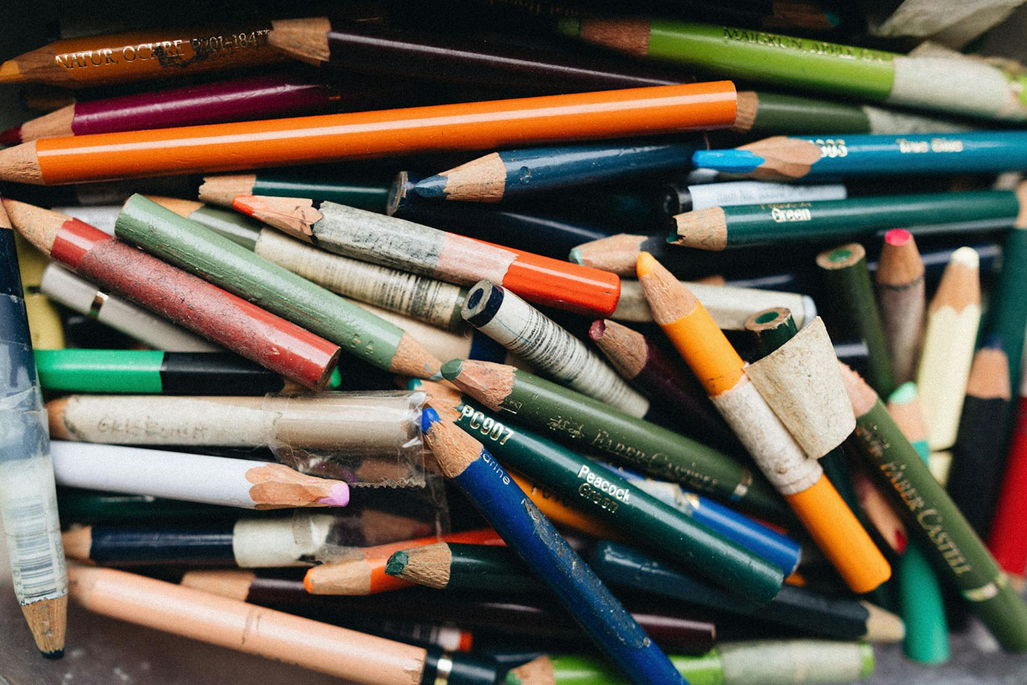 A photograph of a jumble of well-used coloured pencils.