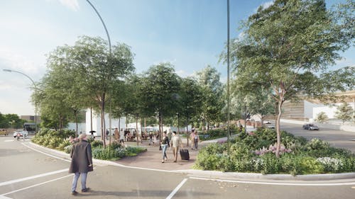 A digital render of a green urban landscape. There is a person crossing the road in the foreground, moving towards two people, one wheeling a suitcase. More people can be seen in a plaza area. Plants cover large areas of the ground, and there is a dense canopy of leafy trees. A car or two can be seen in the distance. 