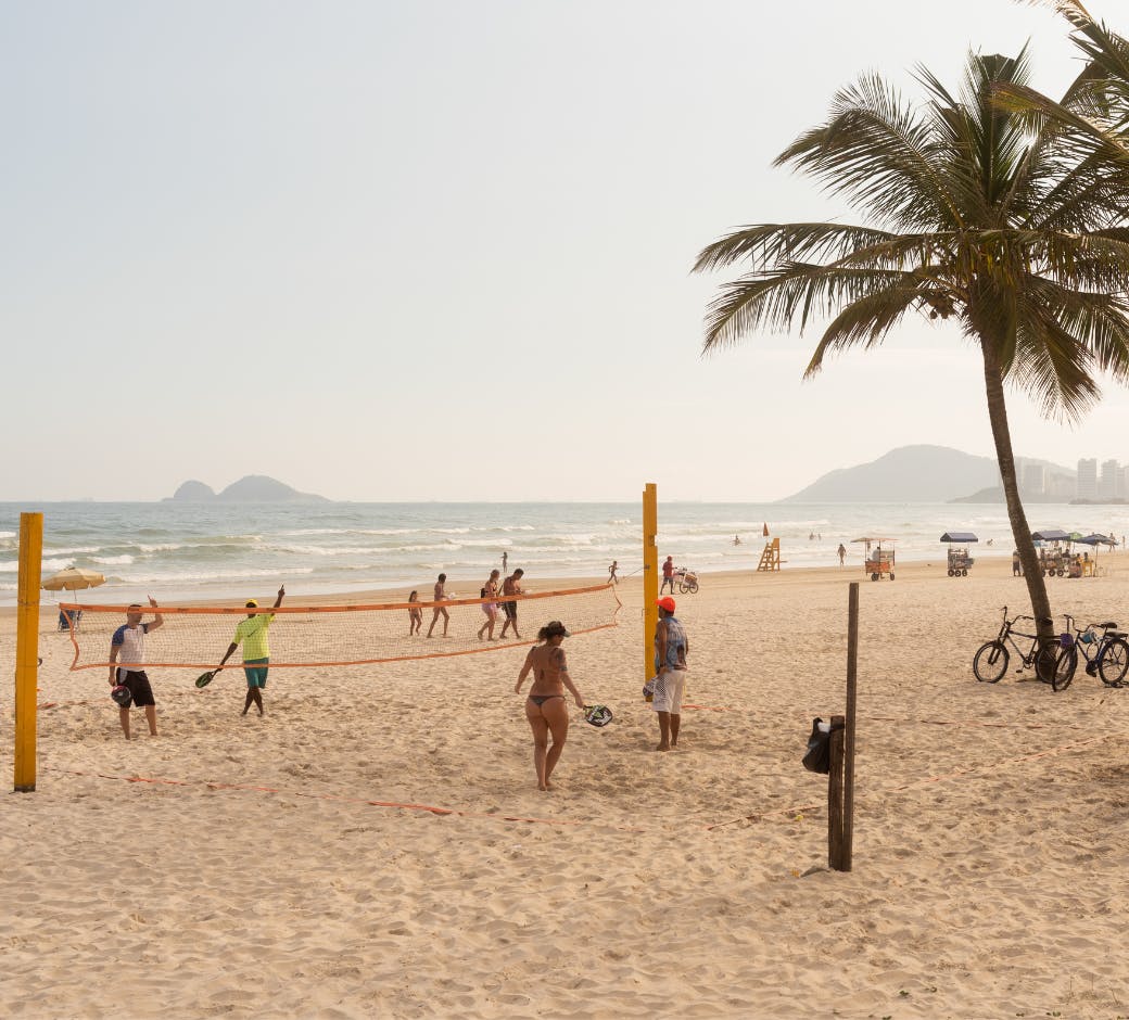 guaruja beach with volleyball net and players