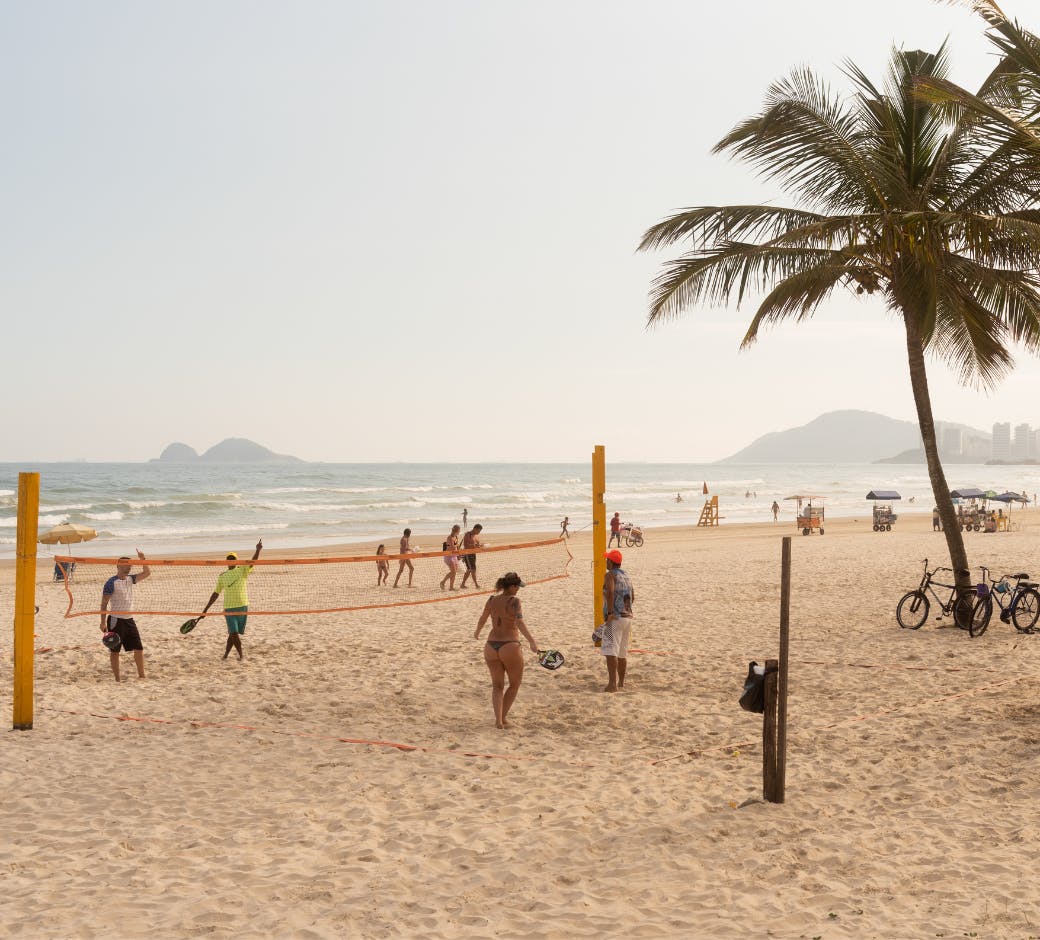 guaruja beach with volleyball net and players