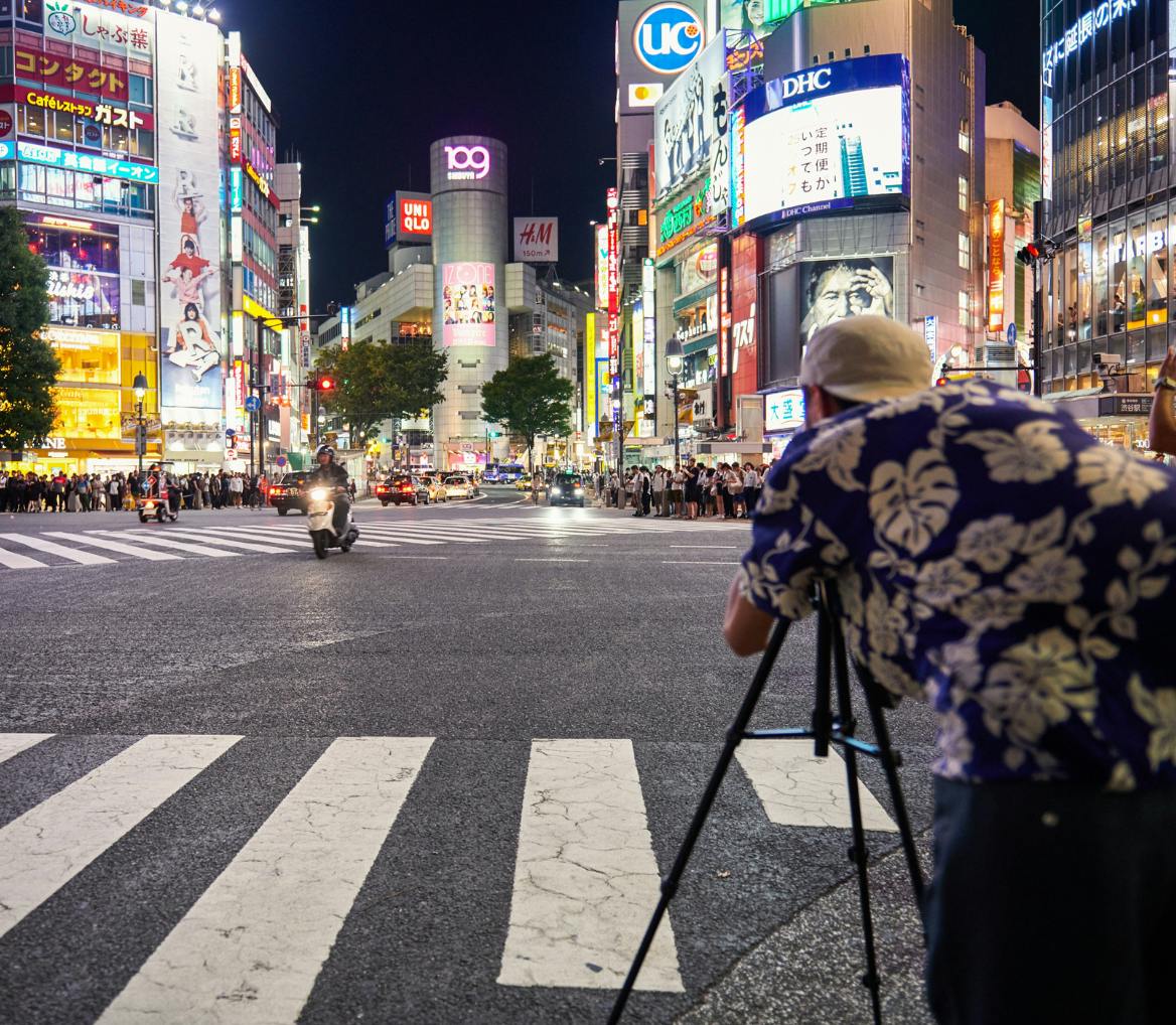 photographer with tripod in tokyo street intersection