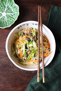 Sweet and sticky pak choi stir fry rice in a white bowl with chopsticks