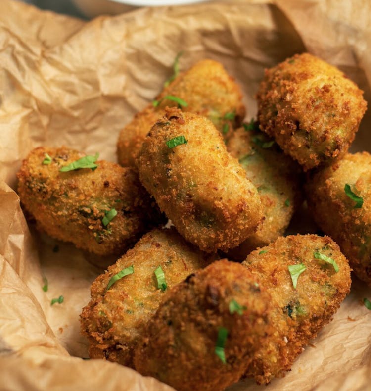 8 crispy golden brown broccoli croquettes garnished with parsley