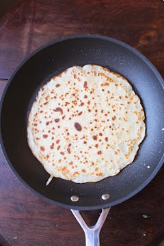 cooked crepe in frying pan