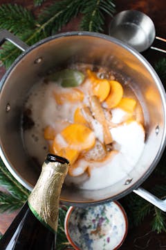 cider being poured into saucepan