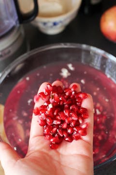pomegranate seeds in a hand 