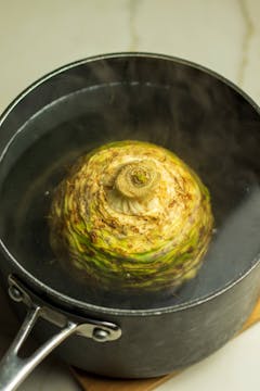  celeriac boiling in a black pan