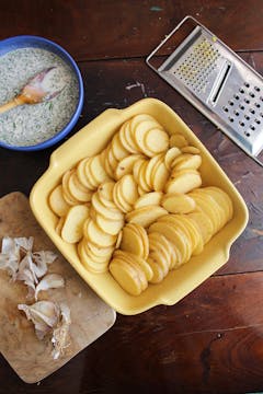 sliced potatoes in a baking dish