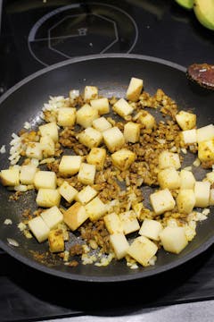cubed potatoes added to the onion and spices