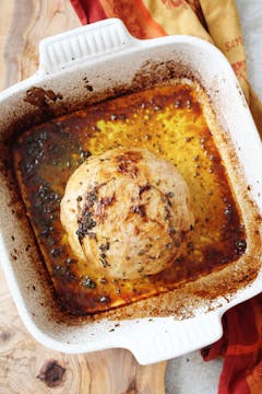 Cabbage after being roasted in a white pan.