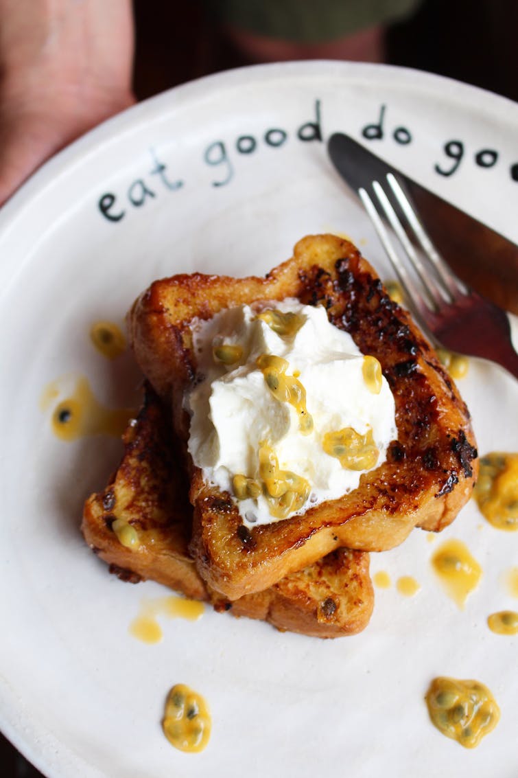 served passionfruit french toast served home made cream and drizzled with passion fruit puree 