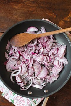 chopped onion on a frying pan
