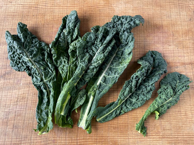 cavolo nero leaves on a wooden table 