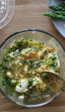 eggs and herbs in mixing bowl