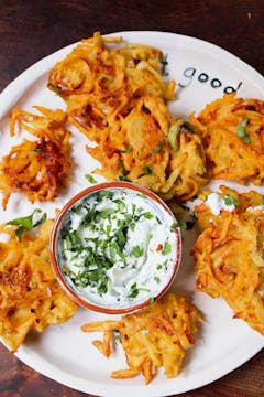 balti paste used to make vegetable bhajis served with a yoghurt baltic dip on a white plate
