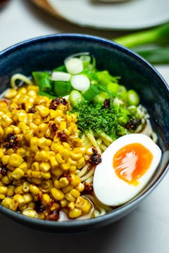 A bowl of Buttered Corn Miso Ramen with a runny egg.