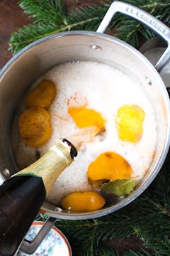 cider being poured into a saucepan 