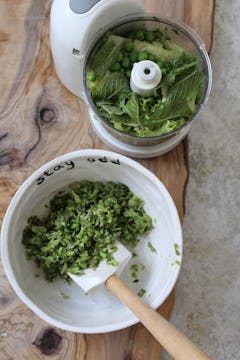 image of lettuce, mint leaves and peas in a food processor