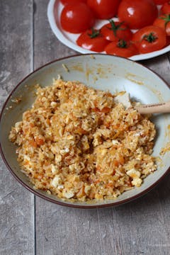 large saucepan with rice, tomatoes onions and seasoning