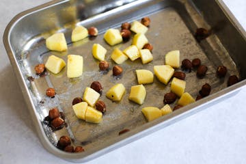 image of apples and nuts in a baking tray