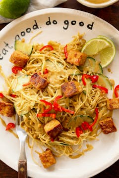 crispy tofu with satay cabbage on a white plate
