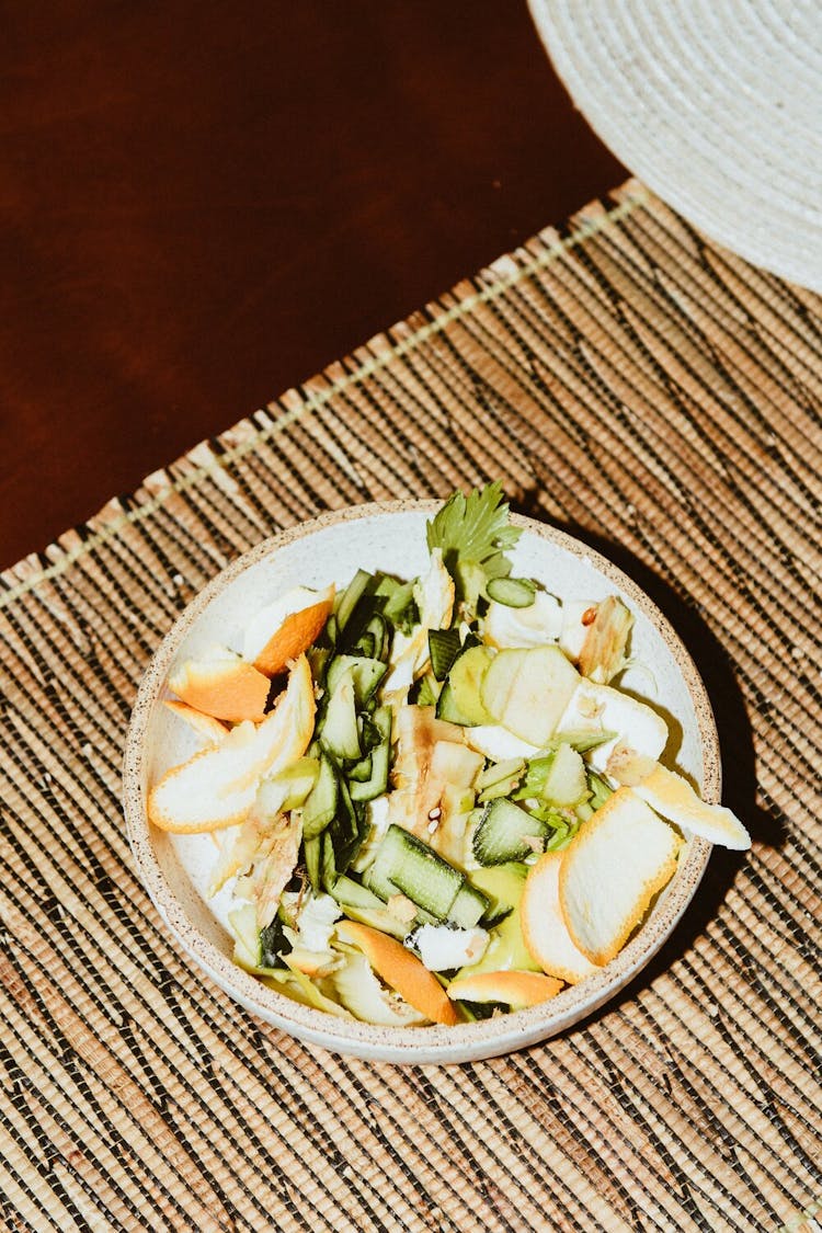 A pile of vegetable scraps in a bowl. 