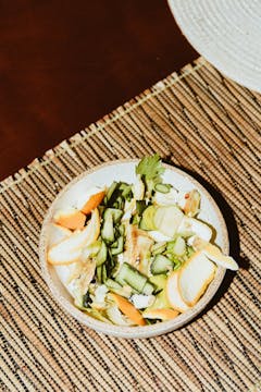 A pile of vegetable scraps in a bowl.