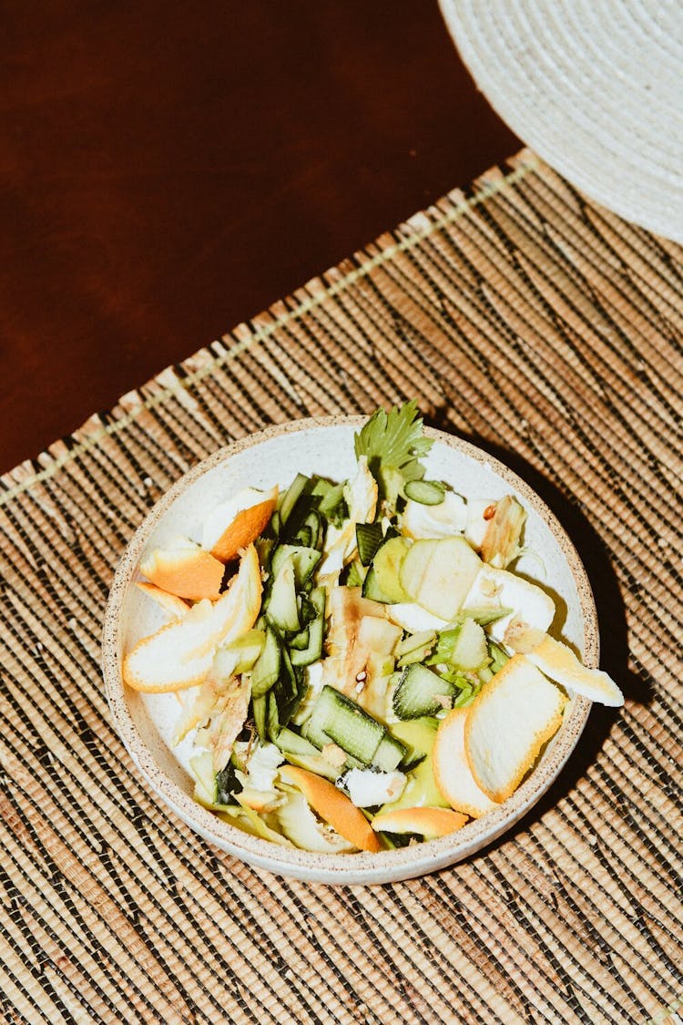 A pile of vegetable scraps in a bowl.