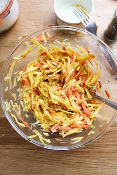 grated carrots in mixing bowl 