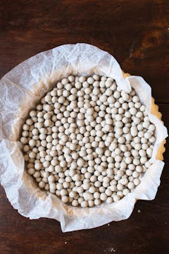 pastry covered with beans on top of baking sheet