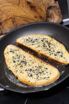 bread slices cooking in frying pan 