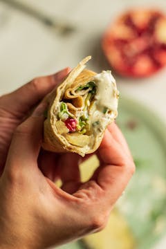 half a wrap with Celeriac Shawarma garlicky sauce, fresh pomegranate and fresh mint