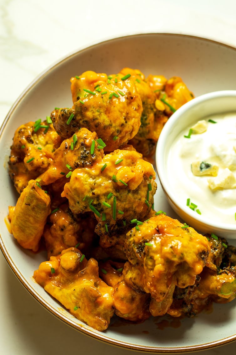A plate of Spicy Buffalo Broccoli Wings with Blue Cheese Sauce
