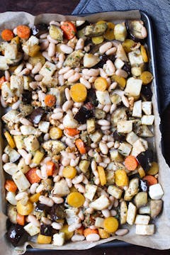 Veggies, rosemary mixture and beans in baking tray